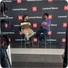 Vishal Rajpurohit being interviewed on camera in front of a Laravel News backdrop