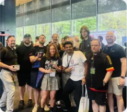 Vishal Rajpurohit in a group photo with conference attendees indoors