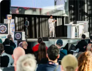 Vishal Rajpurohit presenting to a crowd on an outdoor conference stage