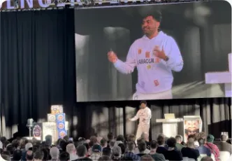 Vishal Rajpurohit on stage, shown on the venue jumbotron wearing a Laracon India hoodie